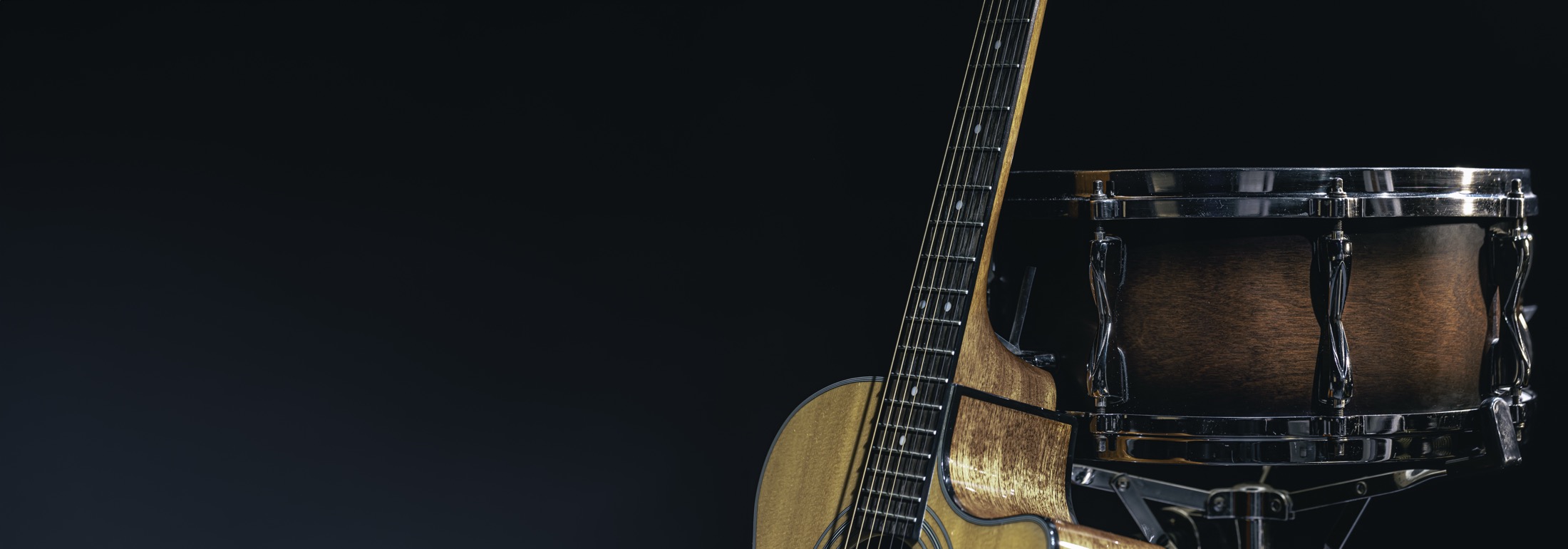 BackPew Music hero background with instruments in shadow